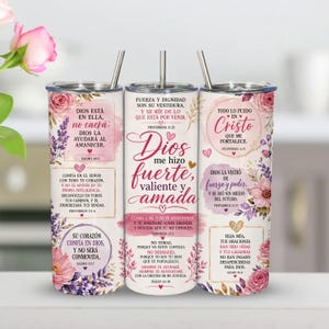 Könnte beinhalten: Drei zylindrische Becher mit Deckeln und Metallstrohhalmen, verziert mit rosa und violetten Blumenmustern, Aquarellakzenten und spanischen religiösen Texten, darunter Bibelverse wie Sprüche 31,25 und Psalm 46,5 in verschiedenen Schriftarten.