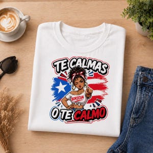 Könnte beinhalten: Weißes T-Shirt mit einer Grafik einer zeigenden Frau und dem Text "TE CALMAS O TE CALMO" darüber und darunter. Das Design enthält die Farben der puerto-ricanischen Flagge und das Wort "BORICUA".