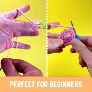 May include: Hands demonstrating crochet techniques with pink yarn and a blue crochet hook. The image shows the beginning stages of a crochet project, with the text "PERFECT FOR BEGINNERS" at the bottom.