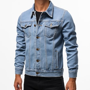 May include: Light blue denim jacket with a classic design. Features a button-down front, two chest pockets, and two side pockets. The jacket has a collared neckline and long sleeves. A timeless piece for casual wear.