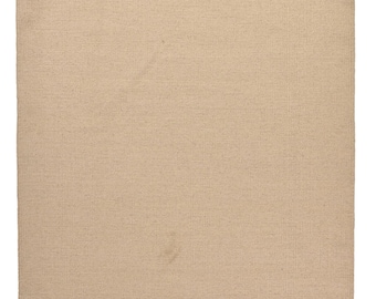 May include: A beige rectangular rug with a woven texture and fringed edges. The rug's neutral colour makes it suitable for various interior design styles. The fringe adds a decorative element to the rug's edges.