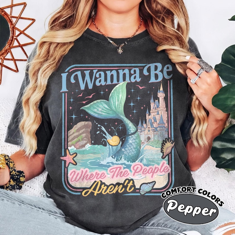 May include: A white ceramic mug with a black handle and the text "But First, Coffee" in a black, handwritten-style font. The mug is on a white surface.