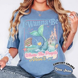 May include: A white ceramic mug with a black handle and the text "But First, Coffee" in a black, bold font. The mug is sitting on a wooden surface. The mug is approximately 4 inches tall.