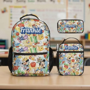 May include: A colorful school set featuring a backpack, pencil case, and lunch bag. The set is decorated with a repeating pattern of cartoon characters, school supplies, and the name "Frankie" in a blue banner.