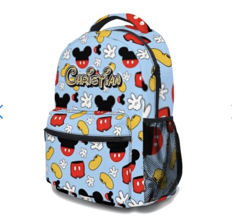 May include: A light blue backpack featuring a pattern of Mickey Mouse heads, gloves, and other elements. The backpack has a front pocket, side mesh pocket, and the name "Christian" in gold script. The handle and zipper pulls are red.