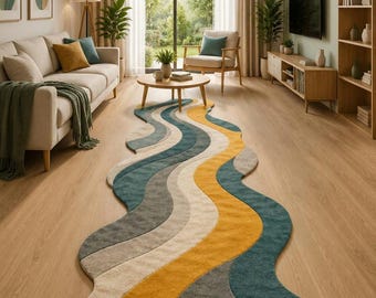 May include: An elongated, wavy area rug featuring a multi-coloured pattern of flowing, curved stripes in shades of mustard yellow, teal, dark grey, and cream. The rug has a soft, textured pile and follows an irregular, organic shape on the floor.