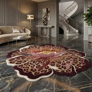 May include: A large, circular area rug shaped like a flower with scalloped edges. The design features a central yellow and pink bloom surrounded by petals with a brown and tan leopard print pattern, finished with a deep burgundy border.