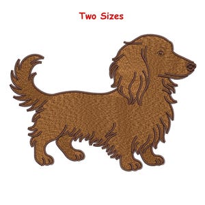 May include: An embroidered image of a brown long-haired dachshund dog. The text "Two Sizes" is in red at the top. The dog is shown in profile, with detailed stitching creating a textured look. The dog has long ears and a fluffy tail.