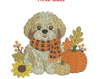 Può includere: Un disegno per ricamo raffigurante un cane soffice beige e bianco che indossa una sciarpa a quadri arancione e nera. Il cane è circondato da un girasole giallo, due zucche arancioni e foglie autunnali. Il testo Three Sizes è in alto.