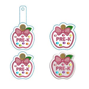 May include: Four embroidered apple-shaped designs featuring the text PRE-K in pink thread. Each apple has a pink bow, a green leaf, and a brown stem, accented with small colourful dots. One design includes a vertical tab with a circular hole at the top.