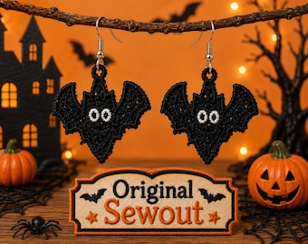 Può includere: Un paio di orecchini a forma di pipistrello nero con occhi ricamati bianchi e ganci in metallo argentato. Sotto gli orecchini si trova una toppa rettangolare con sfondo beige e bordo nero, recante la scritta Original Sewout in arancione.