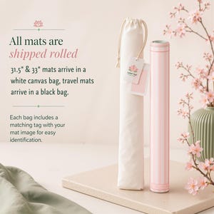 May include: A rolled pink and white striped mat next to a white canvas bag with a drawstring closure. The text on the image says "All mats are shipped rolled" and "31.5" & 33" mats arrive in a white canvas bag, travel mats arrive in a black bag."