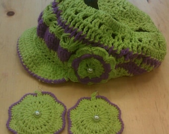 May include: Green and purple crocheted hat with a flower detail and matching crocheted earrings with a pearl accent.