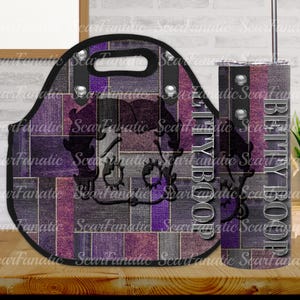May include: A purple and black tote bag and tumbler with a cartoon image of Betty Boop. The bag has a black handle and silver rivets. The tumbler has a black lid and straw. Both items have the text "Betty Boop" printed on them.