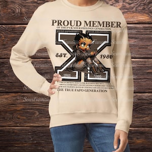 May include: A beige sweatshirt with a brown graphic print of a cartoon character. The graphic includes the text "Proud Member of the F*ck Your Feelings Generation" and "Est. 1980".