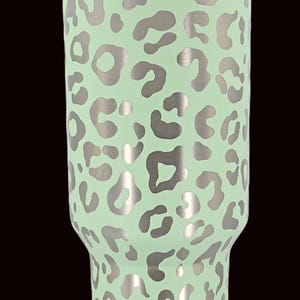 Puede incluir: Un letrero de madera hecho a mano con la palabra "Welcome" en una fuente juguetona. El letrero est&aacute; pintado de blanco con un acabado envejecido y presenta un dise&ntilde;o floral decorativo en tonos rosa y verde. Dise&ntilde;ado para colgar.