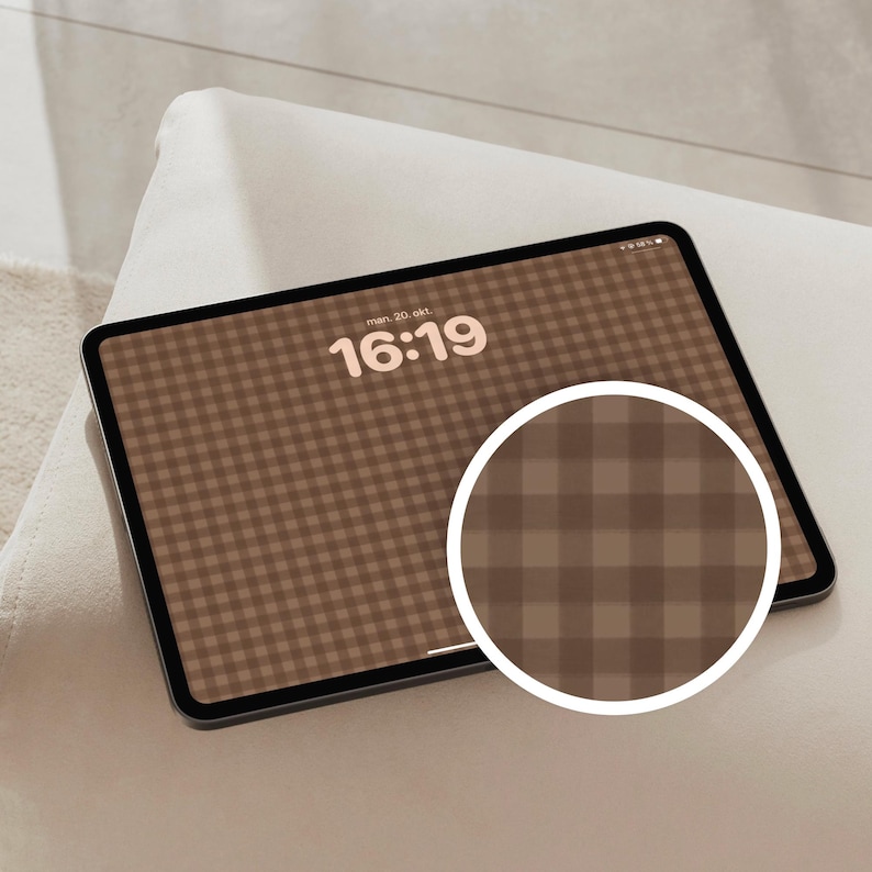 May include: A tablet displaying a brown and beige gingham pattern wallpaper with the time 16:19 and date text visible on the screen. A circular inset shows a magnified view of the checkered pattern, highlighting the brown and beige colour scheme.