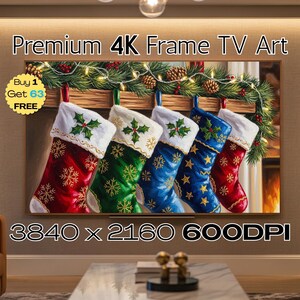 May include: A framed digital artwork showing five Christmas stockings in red, green, and blue, each with snowflake and star patterns. The stockings hang from a wooden beam decorated with festive greenery and lights. The text "Premium 4K Frame TV Art" is displayed at the top.