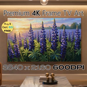 May include: A large, rectangular 4K frame TV displays a vibrant landscape painting. The artwork features tall, purple lupine flowers in a field, with a body of water and a sunset in the background. The text "Premium 4K Frame TV Art" is at the top.
