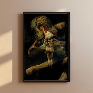 Puede incluir: Impresión enmarcada de "Saturno devorando a su hijo" de Francisco Goya. La obra representa una figura monstruosa consumiendo una forma humana más pequeña, representada en tonos oscuros y terrosos, con énfasis en las expresiones y texturas.