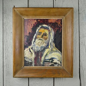 May include: A framed oil painting of a man with a white beard and a white and blue patterned robe. The background is a dark red and brown color.