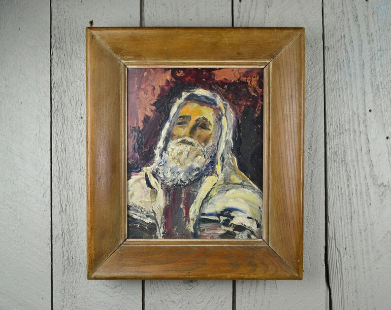 May include: A framed oil painting of a man with a white beard and a white and blue patterned robe. The background is a dark red and brown color.