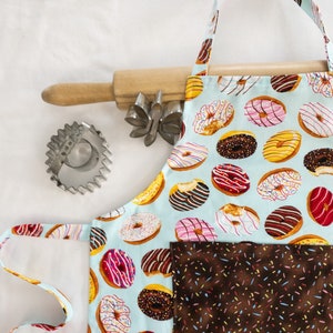 Donuts on Blue Child Apron with brown sprinkles pocket - ready to ship