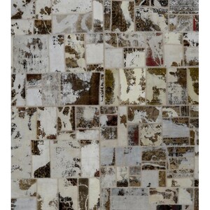 May include: A rectangular patchwork rug with a distressed, vintage aesthetic. The rug features a mix of rectangular and square patches in shades of cream, brown, and gray. Some patches have faded patterns, creating a textured and aged appearance. The rug is suitable for living rooms and bedrooms.