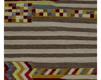 May include: A rectangular rug with a striped pattern in shades of brown, beige, and gray. Accents of red, yellow, blue, and green add a pop of color. The rug features geometric designs and a textured surface, suitable for home decor.