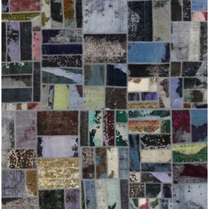 May include: A patchwork rug with a distressed, vintage aesthetic. The rug features a mosaic of rectangular and square patches in various colors, including blues, greens, browns, and purples. The design has a faded, worn appearance, suggesting age and use.