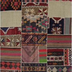 May include: A patchwork rug with a variety of geometric and striped patterns in shades of red, black, beige, and blue. The rug is made of several rectangular pieces sewn together, creating a unique and textured design. The rug is suitable for a living room or bedroom.