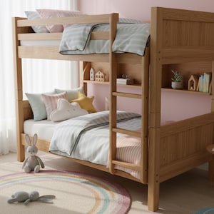 May include: A light-colored wooden bunk bed with a ladder, shelves, and bedding in pastel colors. The bed has a striped comforter and pillows. A stuffed bunny and a rainbow rug are in the foreground. The room has a pink wall.