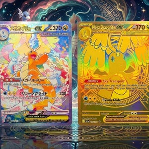 May include: Two trading cards featuring Mega Dragonite EX with 370 HP. The left card has a colorful, holographic illustration of the orange dragon, while the right card is a gold-colored version with the text Mega Dragonite EX and Sky Transport.