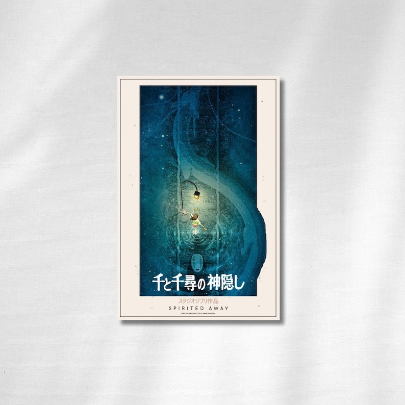 May include: A framed poster featuring a scene from the animated film "Spirited Away." The artwork depicts a blue and teal underwater scene with characters and Japanese text. The poster has a white border and the title "Spirited Away" is written in English.
