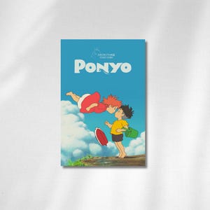 May include: A poster for the animated film "Ponyo." The image shows two characters kissing, with a red-haired figure floating above a boy in a yellow shirt. The background is a blue sky with white clouds. A red and white object is falling.