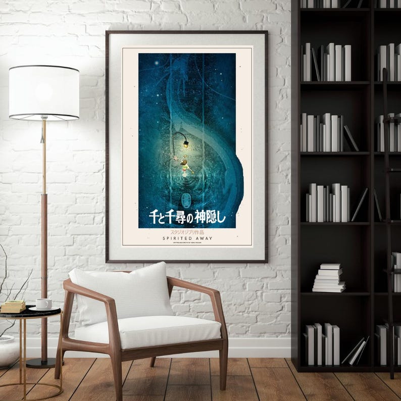 May include: Framed poster featuring artwork from the animated film "Spirited Away." The poster has a dark blue and teal color scheme with Japanese text at the bottom. The poster is displayed in a living room setting.