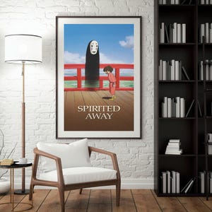 May include: Framed poster featuring a scene from the animated film "Spirited Away." The artwork depicts a character in a red outfit standing on a wooden deck, facing a tall, dark figure. The title "Spirited Away" is printed in white.