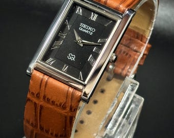 Reloj Seiko Tank vintage: cuarzo fino, esfera negra, correa de piel