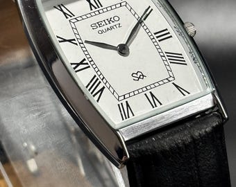 Vintage Seiko Slim Herren Panzerarmbanduhr: Weißes Zifferblatt mit römischen Ziffern