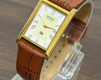 Reloj de pulsera vintage Seiko Slim Tank de cuarzo chapado en oro para hombre, esfera romana, correa de cuero