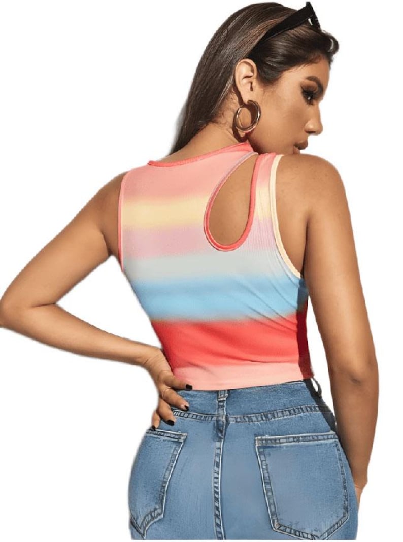 May include: A sleeveless crop top with a colorful, horizontal striped pattern in shades of red, orange, yellow, blue, and pink. The top has a unique cutout detail on the shoulder and is paired with blue denim jeans.
