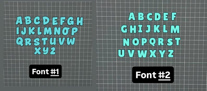 May include: Two sets of the alphabet in a light blue color, displayed on a gray grid background. The first set, labeled "Font #1", features a rounded, bubble-style font. The second set, labeled "Font #2", has a more standard, block-letter style.