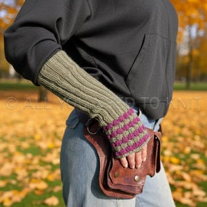 May include: Olive green and purple striped fingerless gloves. The gloves are worn with a black hoodie and blue jeans. A brown leather fanny pack is also visible. The text "ALL YOU NEED TO KNIT" is in the image.
