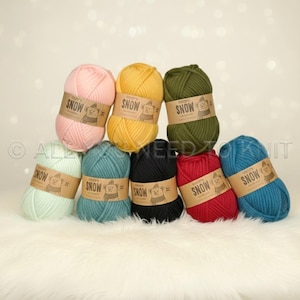 May include: Eight skeins of yarn in various colors including light pink, yellow, olive green, mint green, teal, black, red, and blue. Each skein features a tan paper label with the text "DROPS SNOW" and a graphic of a bear wearing a hat.