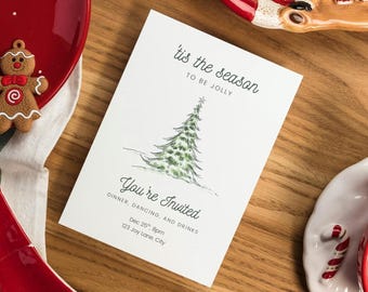 May include: A white invitation card with the text "'tis the season to be jolly" and "You're Invited" with a Christmas tree illustration. The card includes details for a dinner, dancing, and drinks event on December 25th at 8 pm, located at 123 Joy Lane, City.