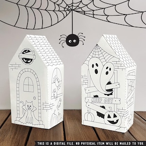 May include: Two white, house-shaped Halloween-themed boxes with black line art. One features a cat, door, and pumpkins; the other has ghosts, a jack-o'-lantern, and a "KEEP OUT" sign. A spider and web are above. Text: THIS IS A DIGITAL FILE. NO PHYSICAL ITEM WILL BE MAILD TO YOU.