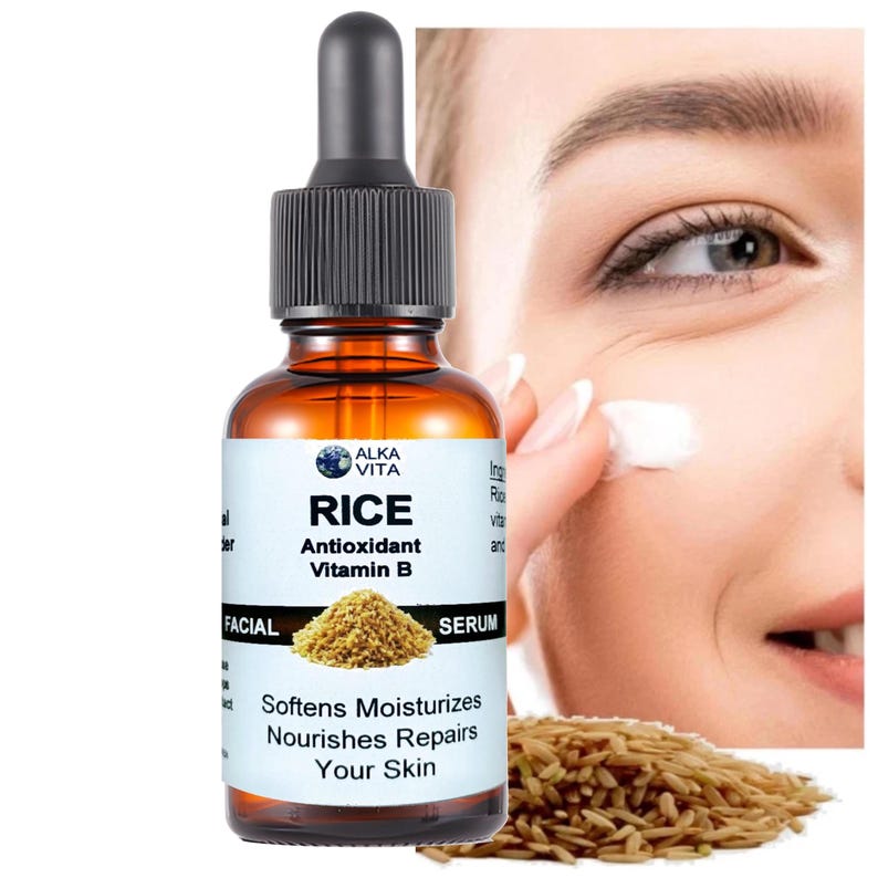 May include: An amber glass dropper bottle of Alka Vita Rice Antioxidant Vitamin B facial serum. The white label features the text Rice Antioxidant Vitamin B, Softens Moisturizes Nourishes Repairs Your Skin, and an image of a pile of brown rice.