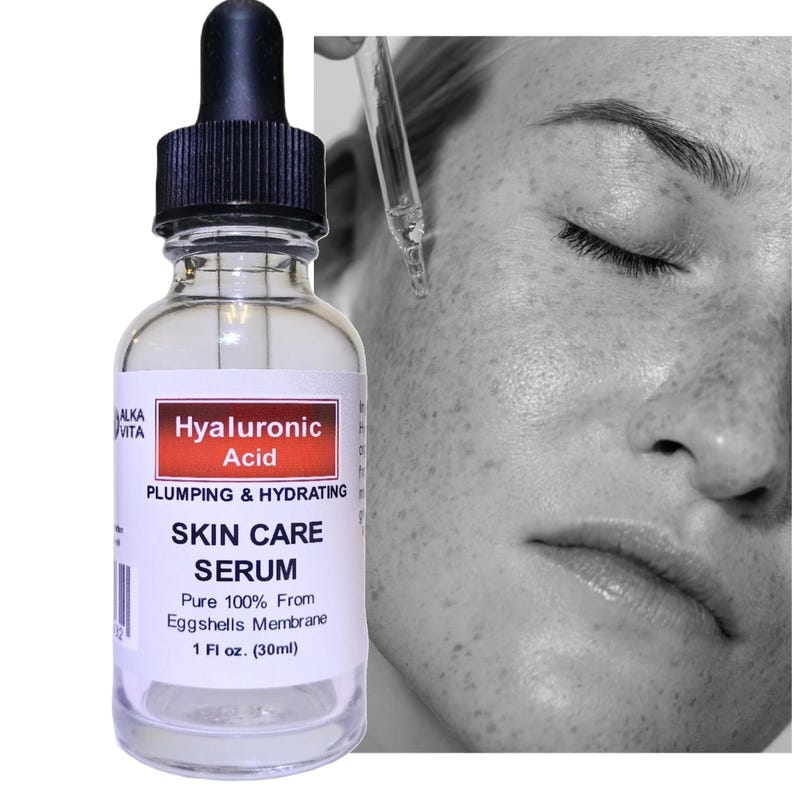 May include: A clear glass bottle of Alka Vita Hyaluronic Acid skin care serum with a black dropper cap. The label reads Hyaluronic Acid, Plumping & Hydrating, Skin Care Serum, Pure 100% From Eggshells Membrane, and 1 Fl oz. (30ml).