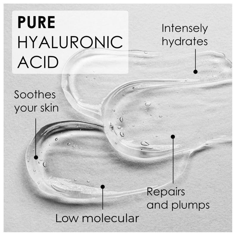 May include: A clear, viscous gel of pure hyaluronic acid spread in two distinct strokes. Text labels indicate the product intensely hydrates, soothes your skin, repairs and plumps, and features a low molecular weight formula for skin care.