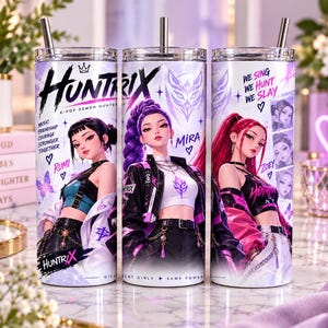May include: A cylindrical tumbler with a metal straw featuring a graphic print of three anime-style characters. The text reads Huntrix, K-Pop Demon Hunters, Rumi, Mira, Zoey, We Sing We Hunt We Slay, and Different Girls Same Power with purple accents.